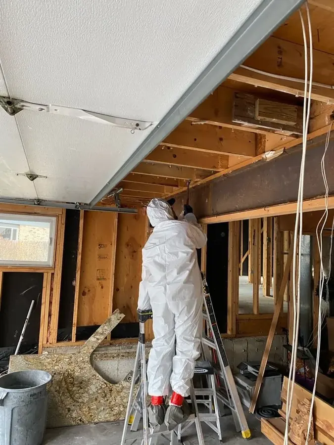 Technician removing water-damaged framing in a Milwaukee home