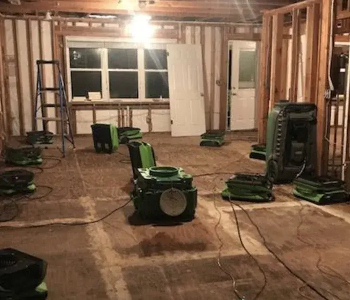 Air movers drying a gutted Milwaukee lower level