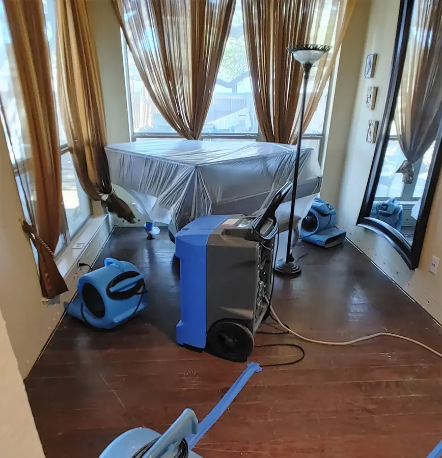 Covered furniture and drying equipment in a Milwaukee living room